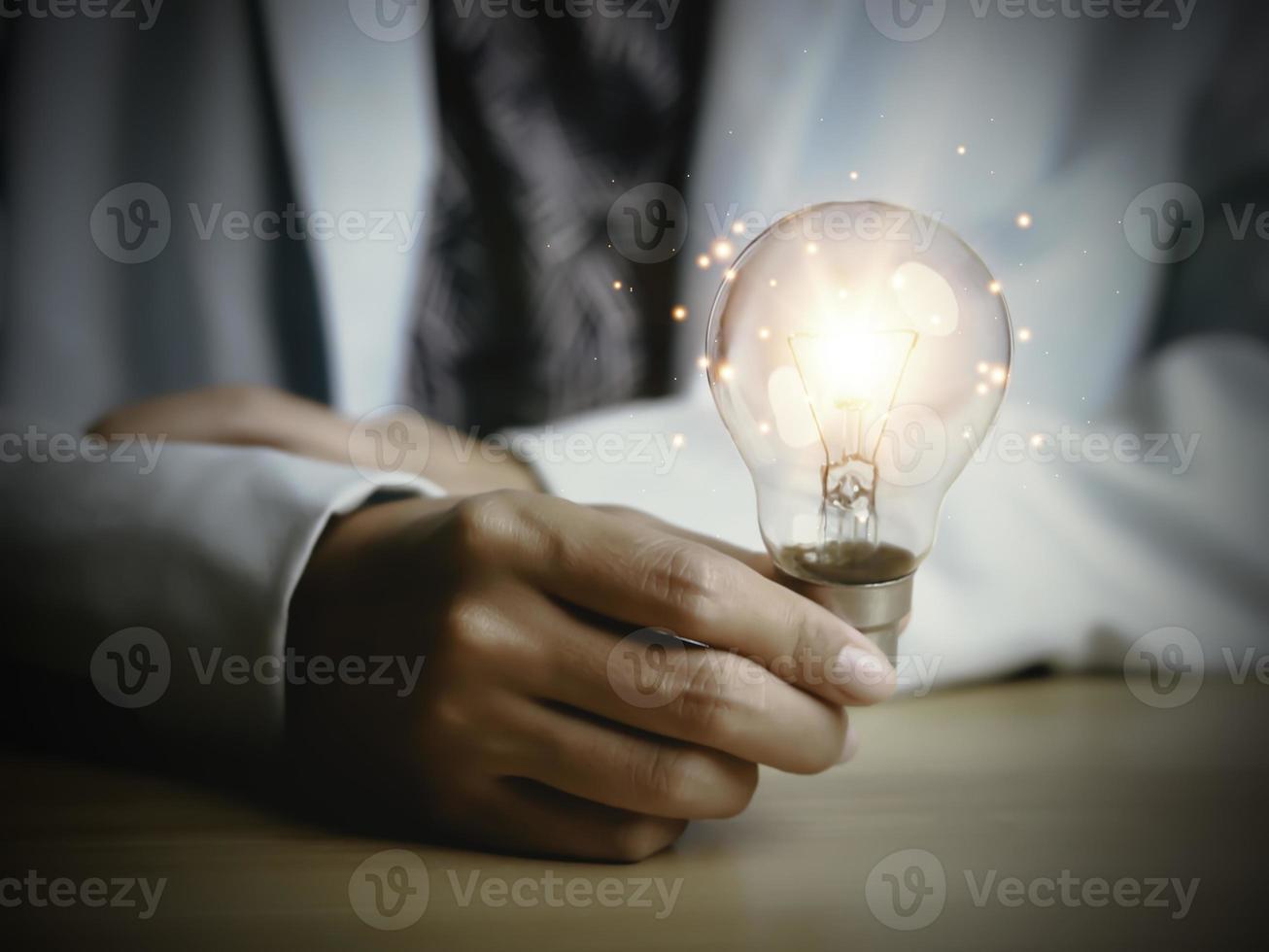 Businesswoman holding a light bulb, Creative new idea. Innovation, brainstorming, solution and inspiration concepts. imagination, creative thinking problem solving. photo