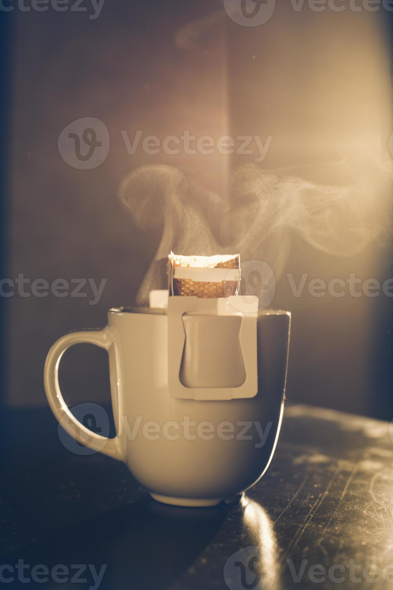 The process of brewing coffee. Water is poured into a drip coffee bag