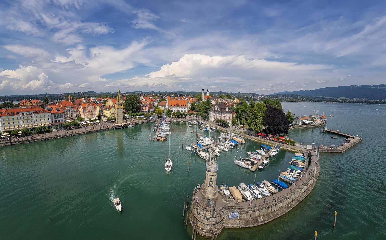 Lindau, Germany - July.21 2019, Harbor on Lake Constance with a statue of a lion at the entrance in Lindau, Bavaria, Germany photo