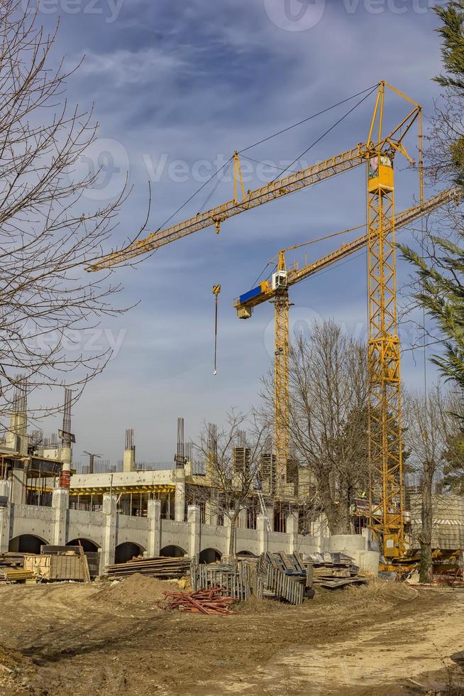 Construction site with cranes and building photo