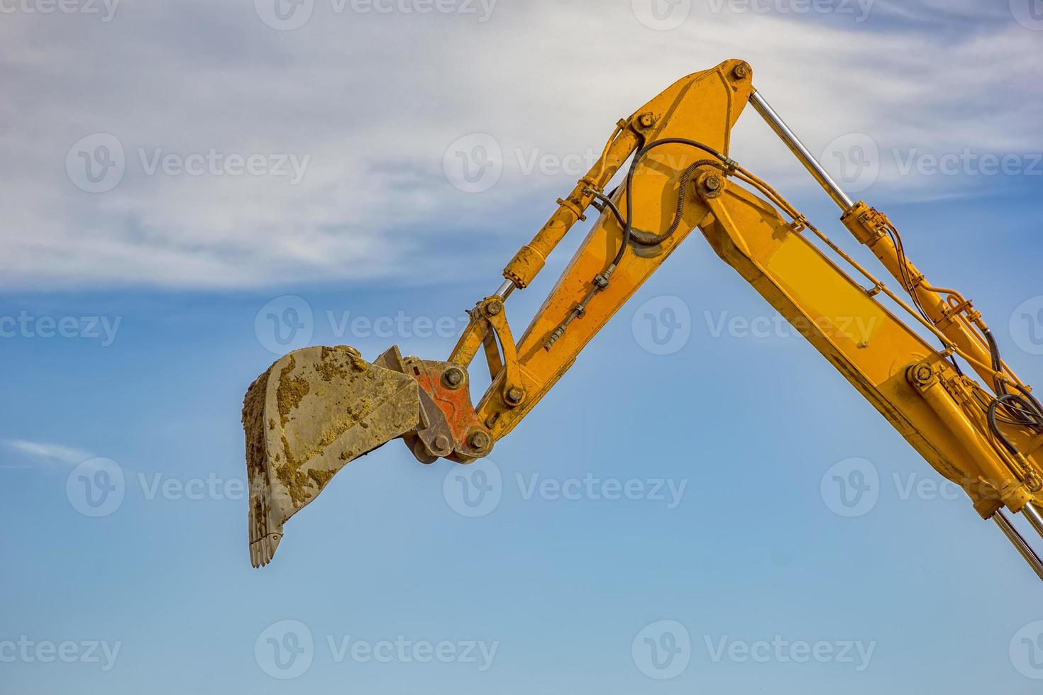 day view of single excavator boom arm with hydraulic Hoses and cylinder in action. Close photo