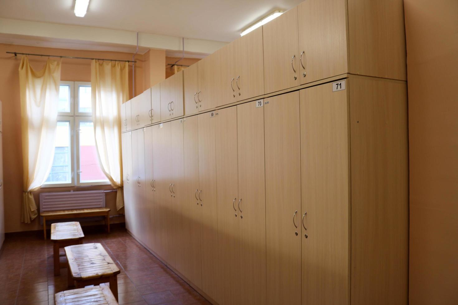 Room, locker room for workers with individual lockers for changing clothes in an industrial plant photo