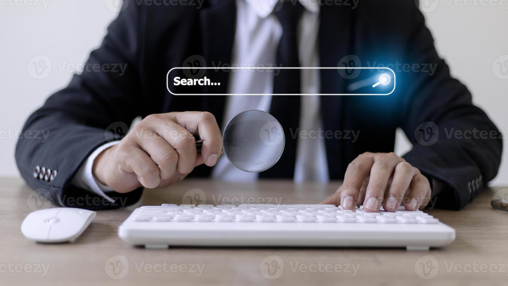 People hand using laptop or computor searching for information in internet online society web with search box icon and copyspace. photo