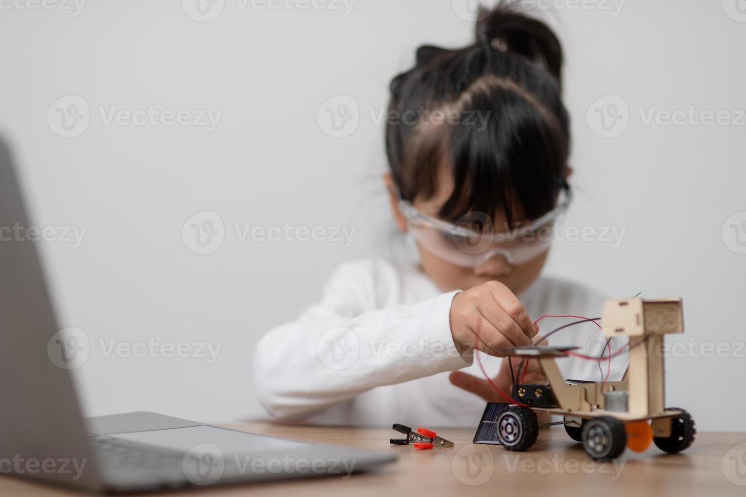 Asia students learn at home in coding robot cars and electronic board cables in STEM, STEAM, mathematics engineering science technology computer code in robotics for kids concept. photo