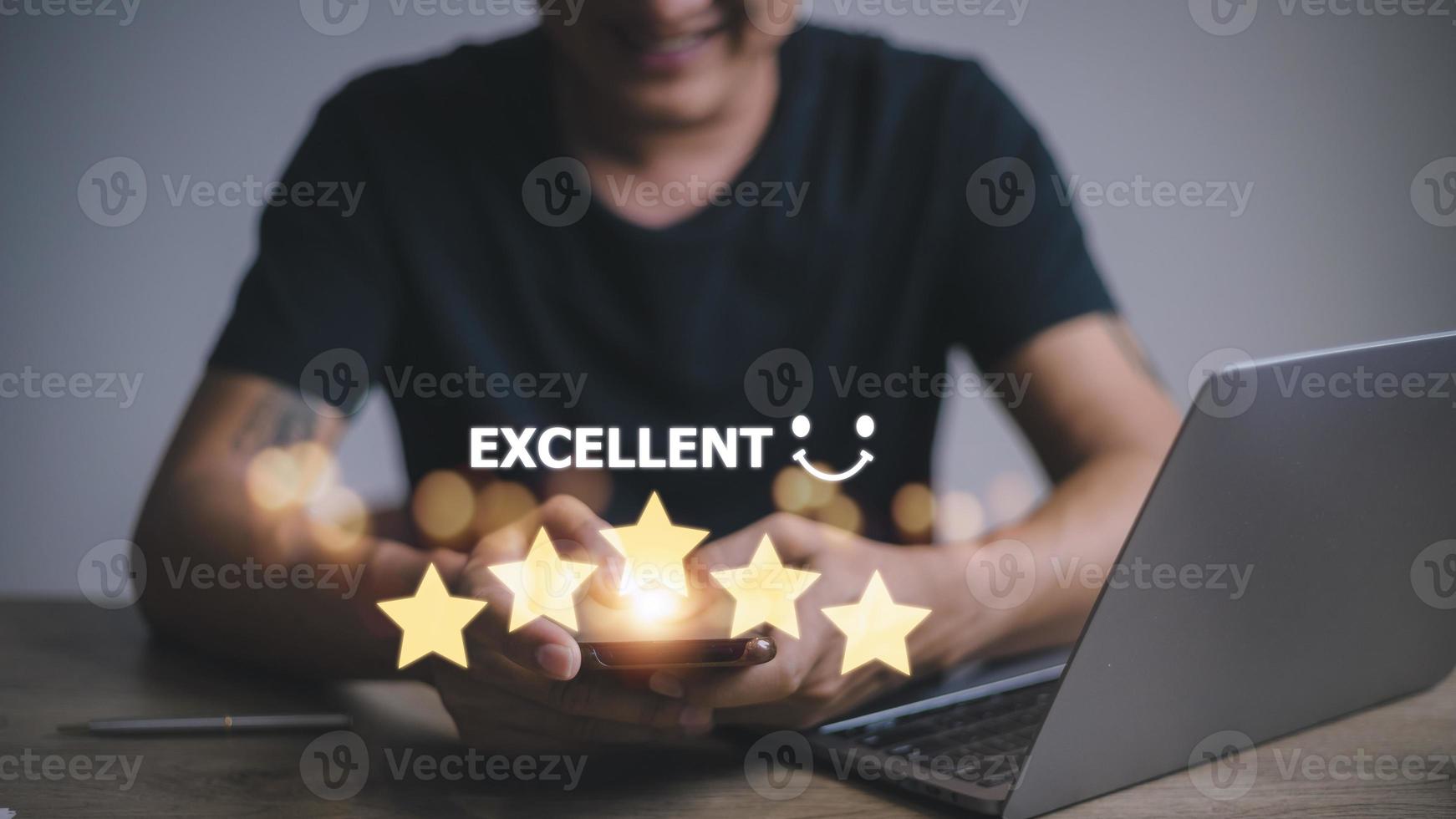 customer hand with gold five star rating feedback icon and press level excellent rank for giving best score point to review the service, business concept photo