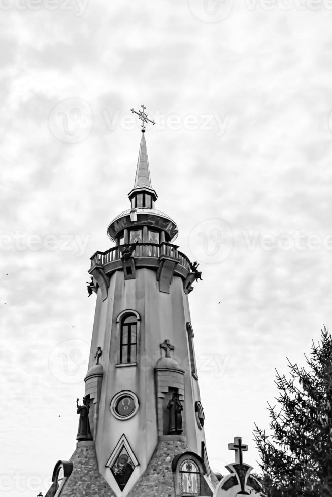 Christian church cross in high steeple tower for prayer photo