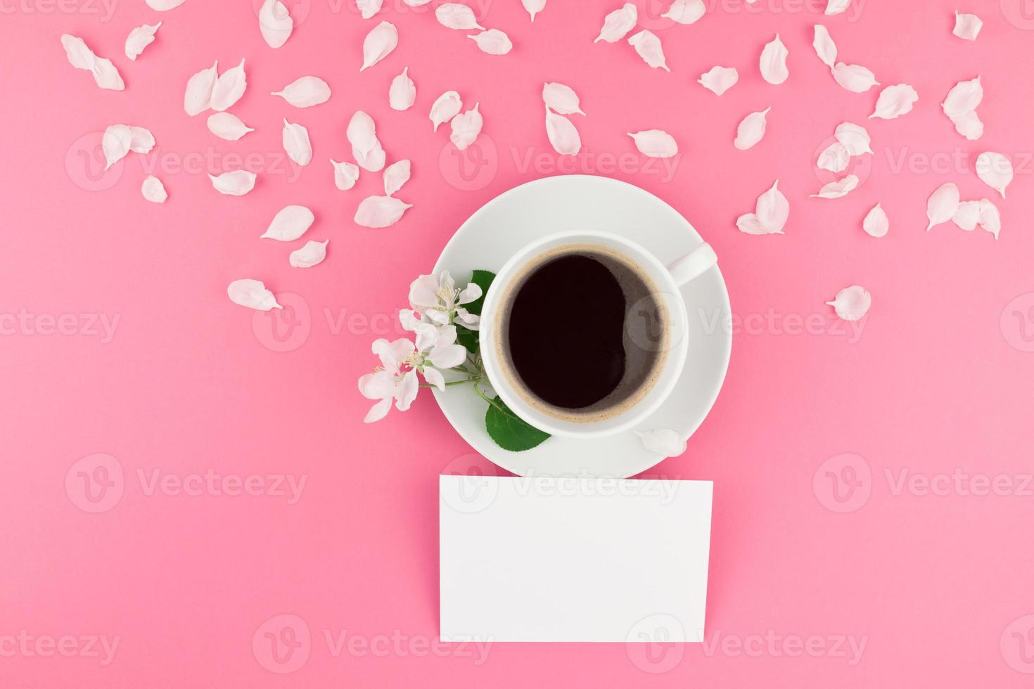 Flat lay of coffee, letter mockup and white petals photo