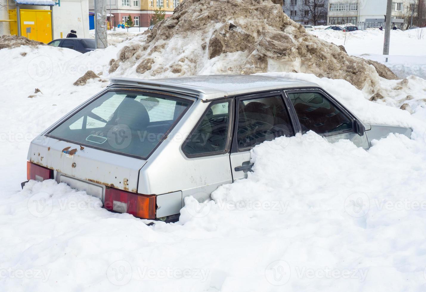 the car got stuck in the snow. Left for the winter under the snow photo