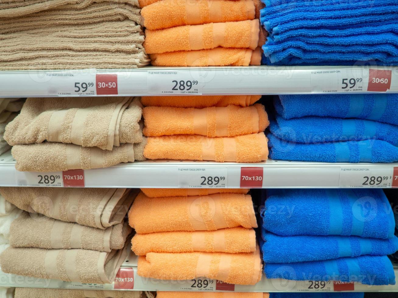 Shelves in the store. Laying out goods in a supermarket. Sale of towels. photo