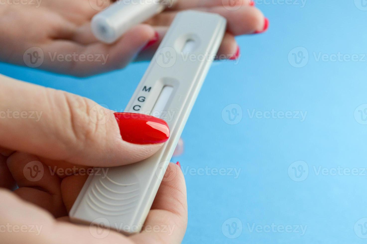 testing for antibodies. a blood test by a quantitative method to determine the coronavirus. girl with red nails is about to prick her finger. testing for IgG and IgM antibodies photo