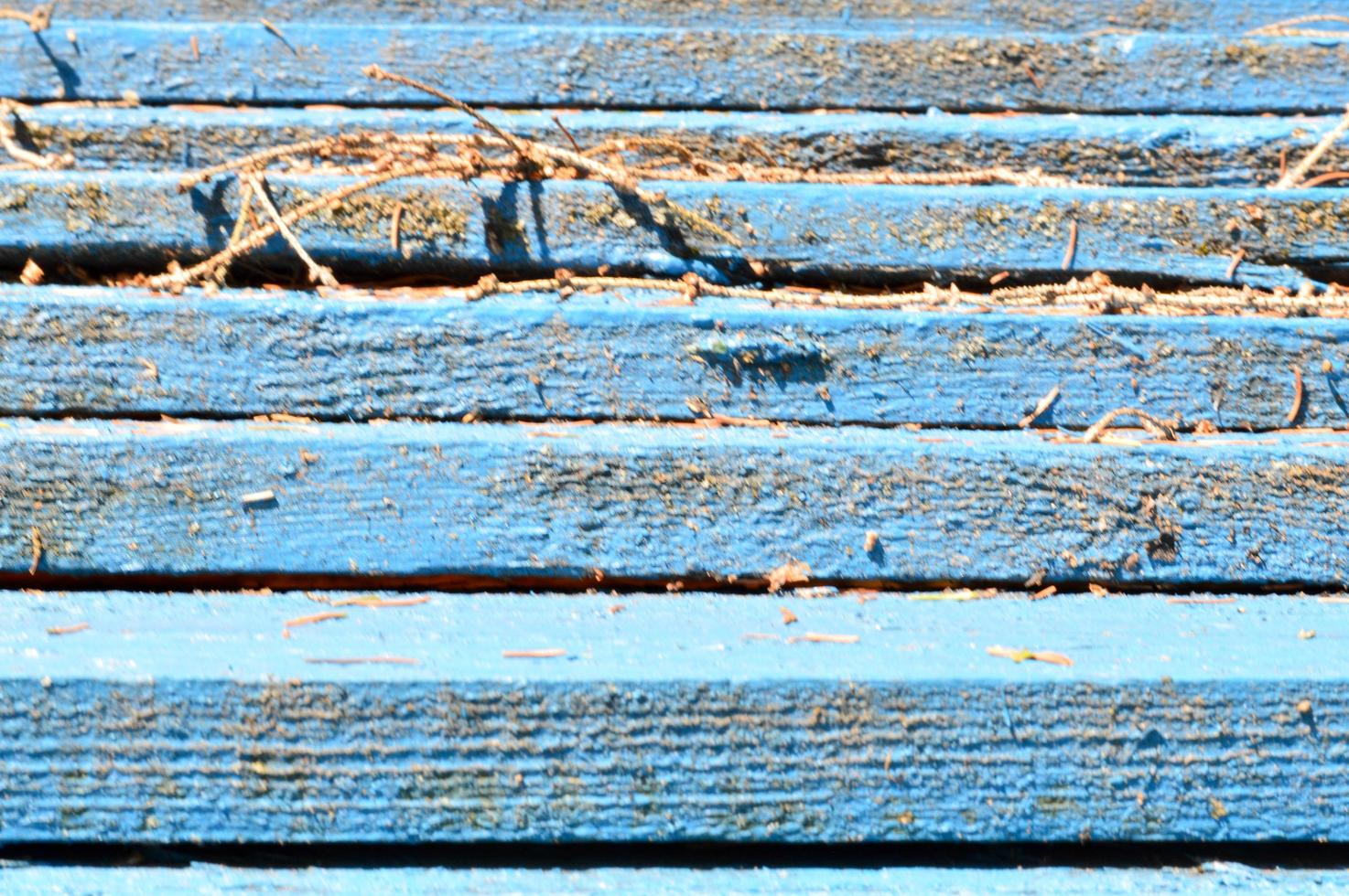 The texture of wooden boards is blue with seams horizontally painted with natural paint. The background photo