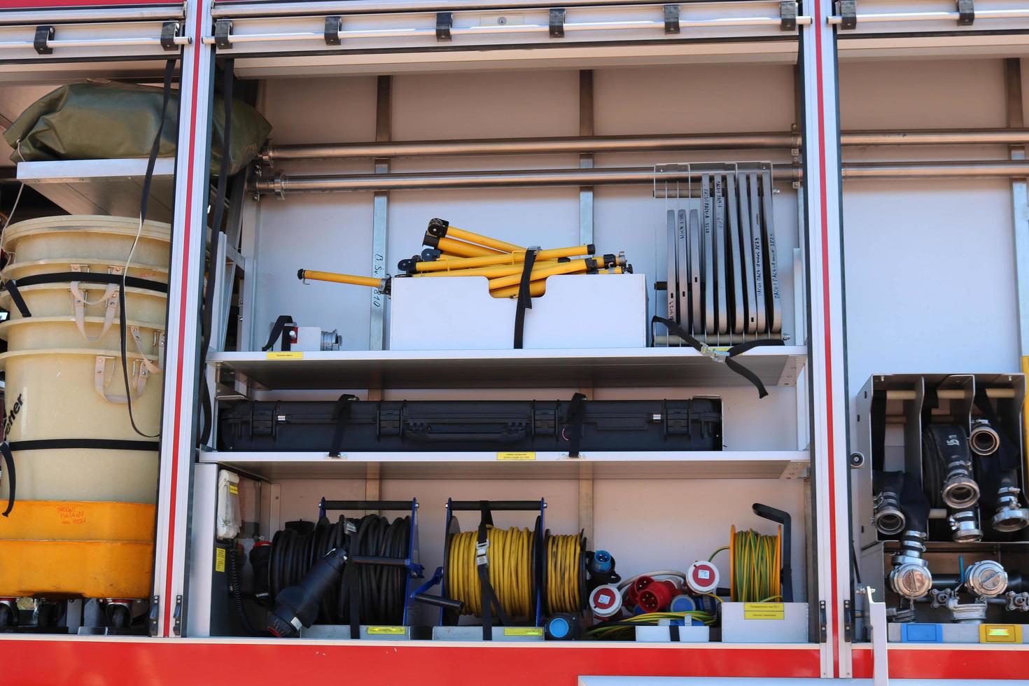 coche de bomberos grande especial rojo con azul, motor para rescatar personas con los lados abiertos y equipo de extinción, bomba contra incendios, agente de soplado, herramienta, manguitos de agua, mangueras, balones, equipo foto