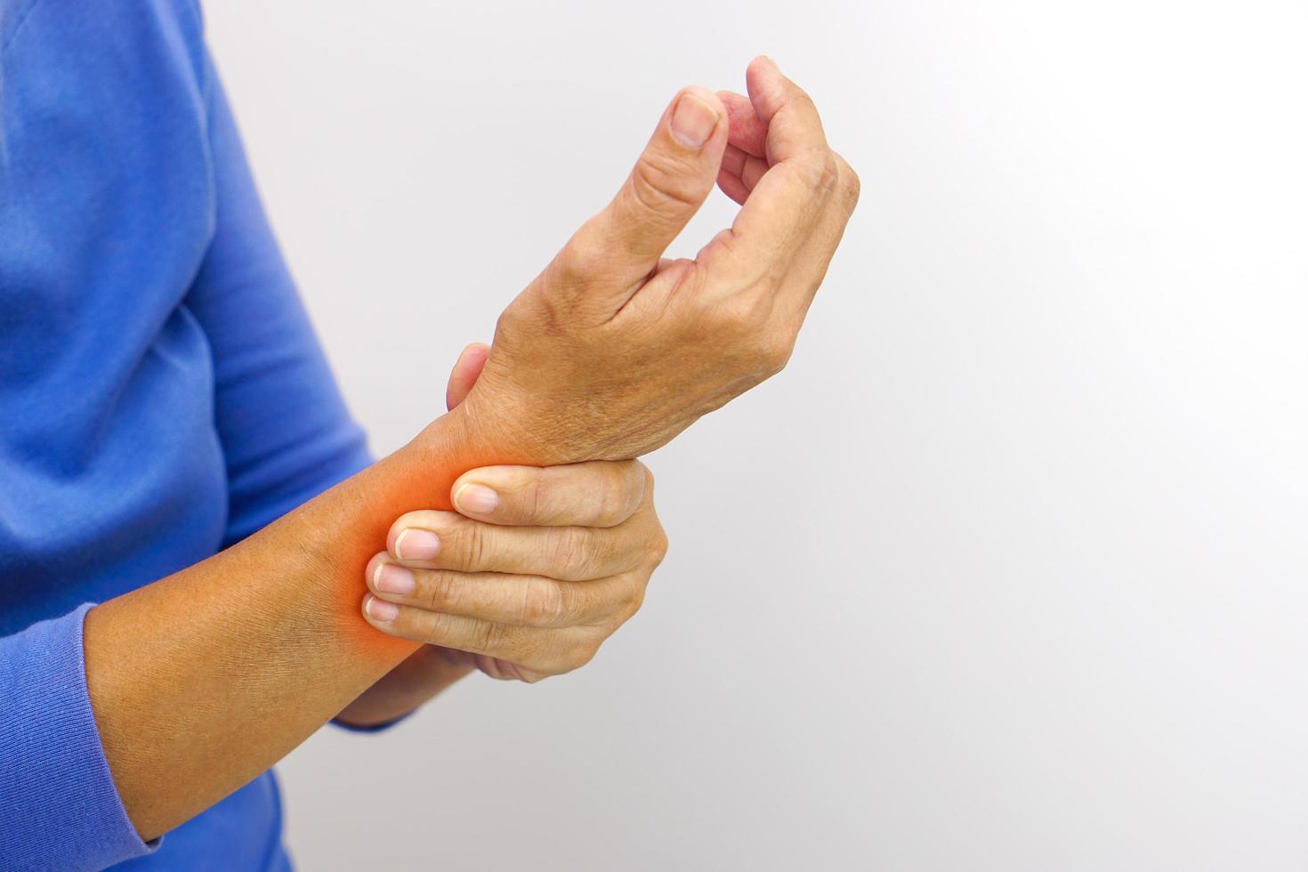 Woman with pain in wrist on white background. Healthcare and office syndrome concept. photo