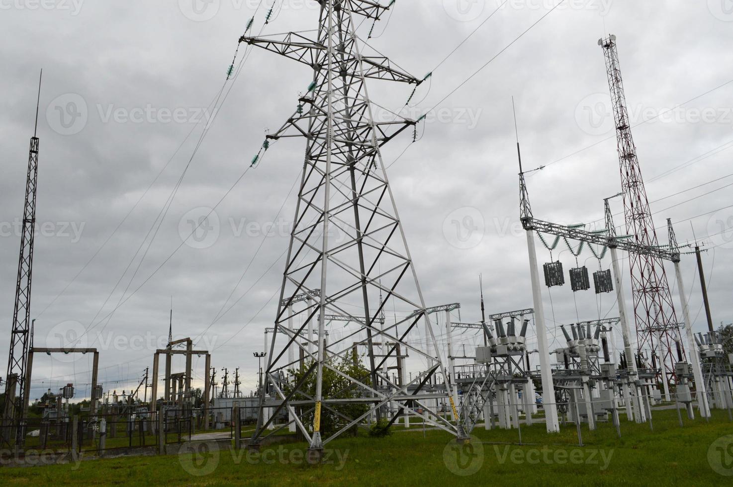 Metal transmission line with the components of the electric network, the system of power equipment for the transmission of electricity, electric current with the transformer at the power station photo