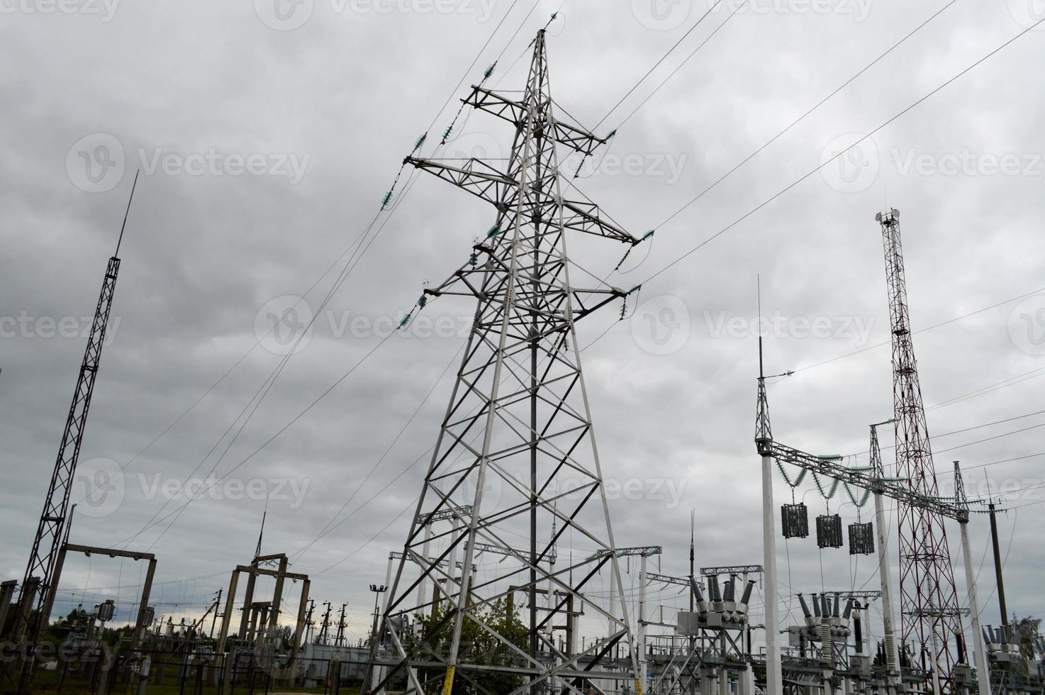 Metal transmission line with the components of the electric network, the system of power equipment for the transmission of electricity, electric current with the transformer at the power station photo