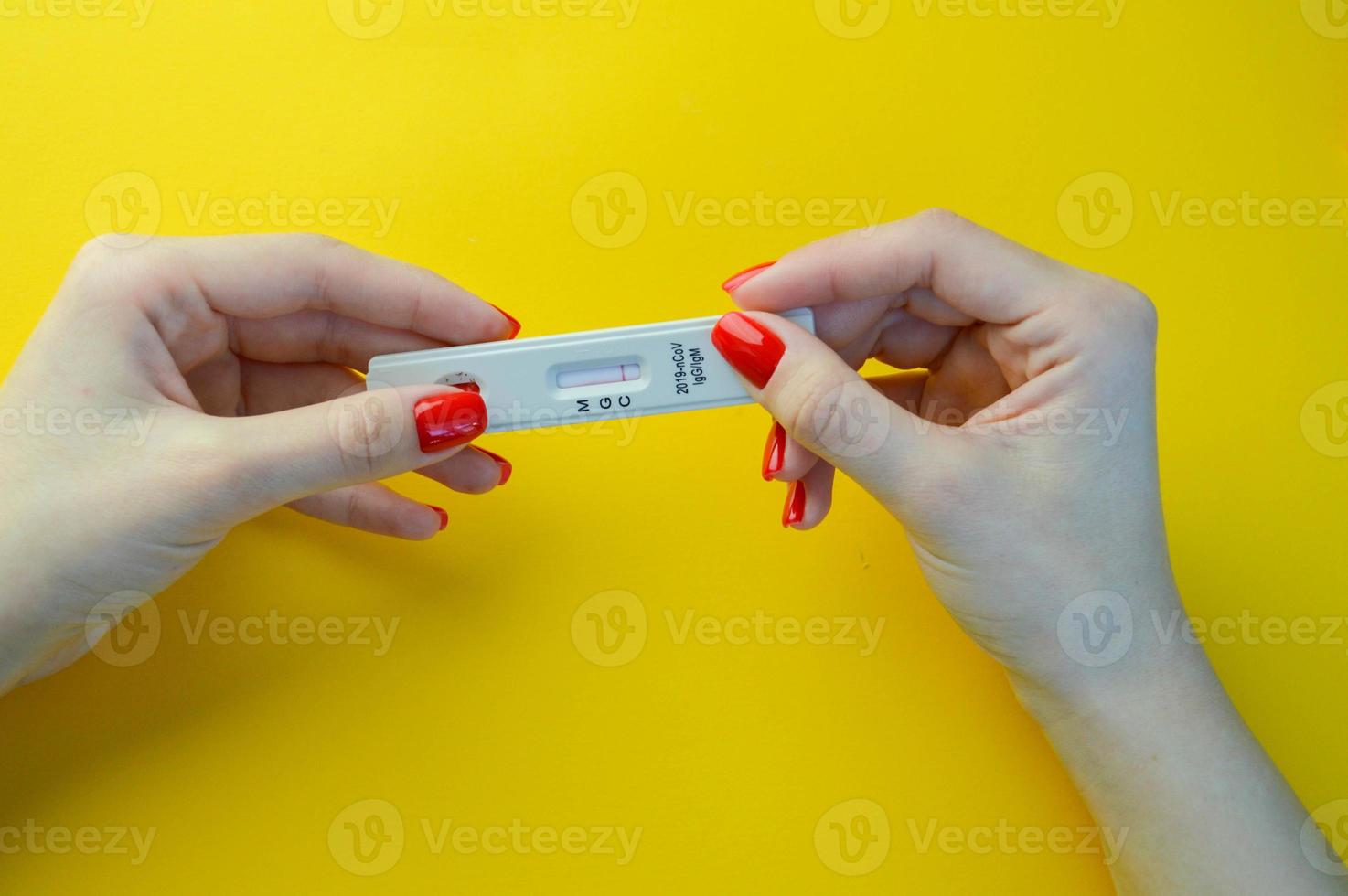 COVID-19 test to detect IgM and IgG antibodies to Novel Coronavirus, SARS-CoV-2 with positive result.Coronavirus Express Testing card. Covid-19 rapid test, on pink background. Coronavirus test photo