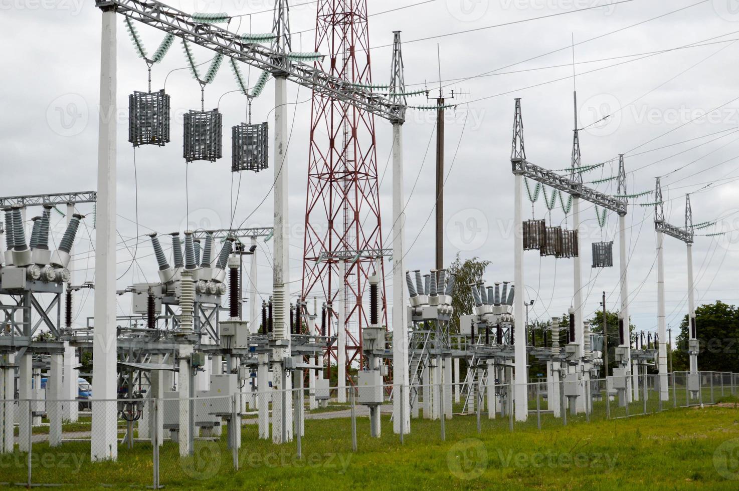 línea de transmisión metálica con los componentes de la red eléctrica, el sistema de equipos de potencia para la transmisión de electricidad, corriente eléctrica con el transformador en la central eléctrica foto