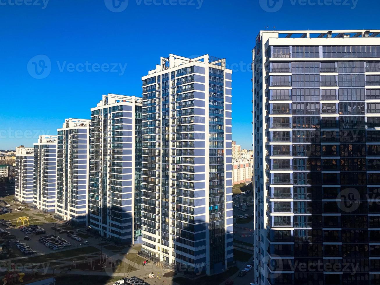 View of the new beautiful residential complex from new buildings with buildings houses monolithic concrete frame panel multi-story skyscrapers of the big city of the metropolis photo