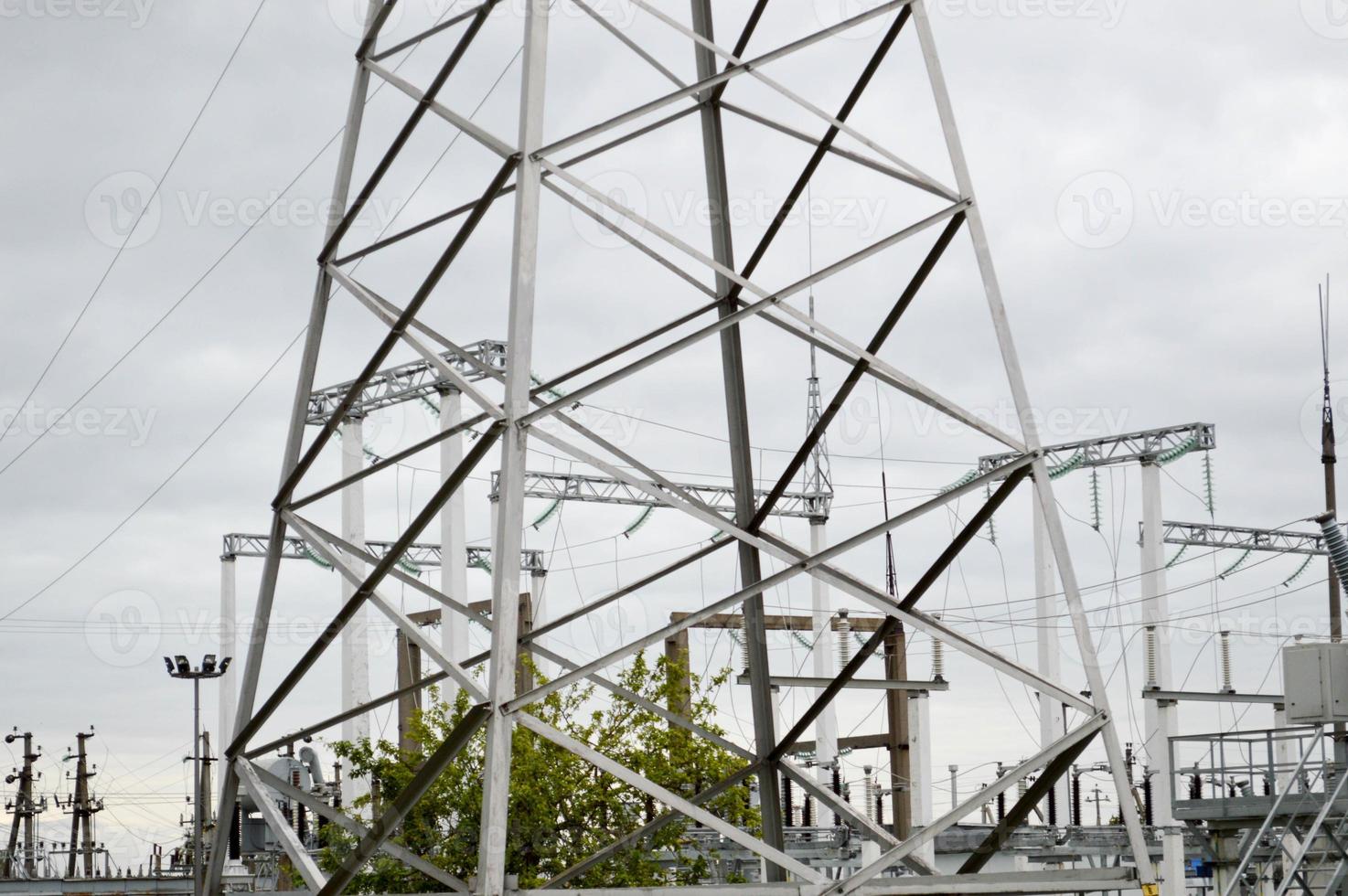 Metal transmission line with the components of the electric network, the system of power equipment for the transmission of electricity, electric current with the transformer at the power station photo