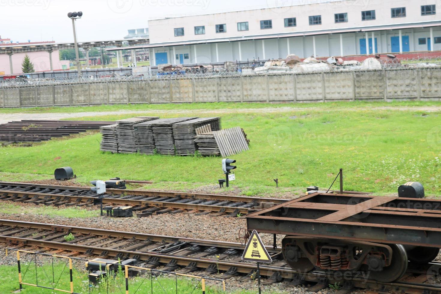 Rusty empty metal iron wheeled freight car for the train, locomotive for the carriage of goods along the rails at the railway station photo