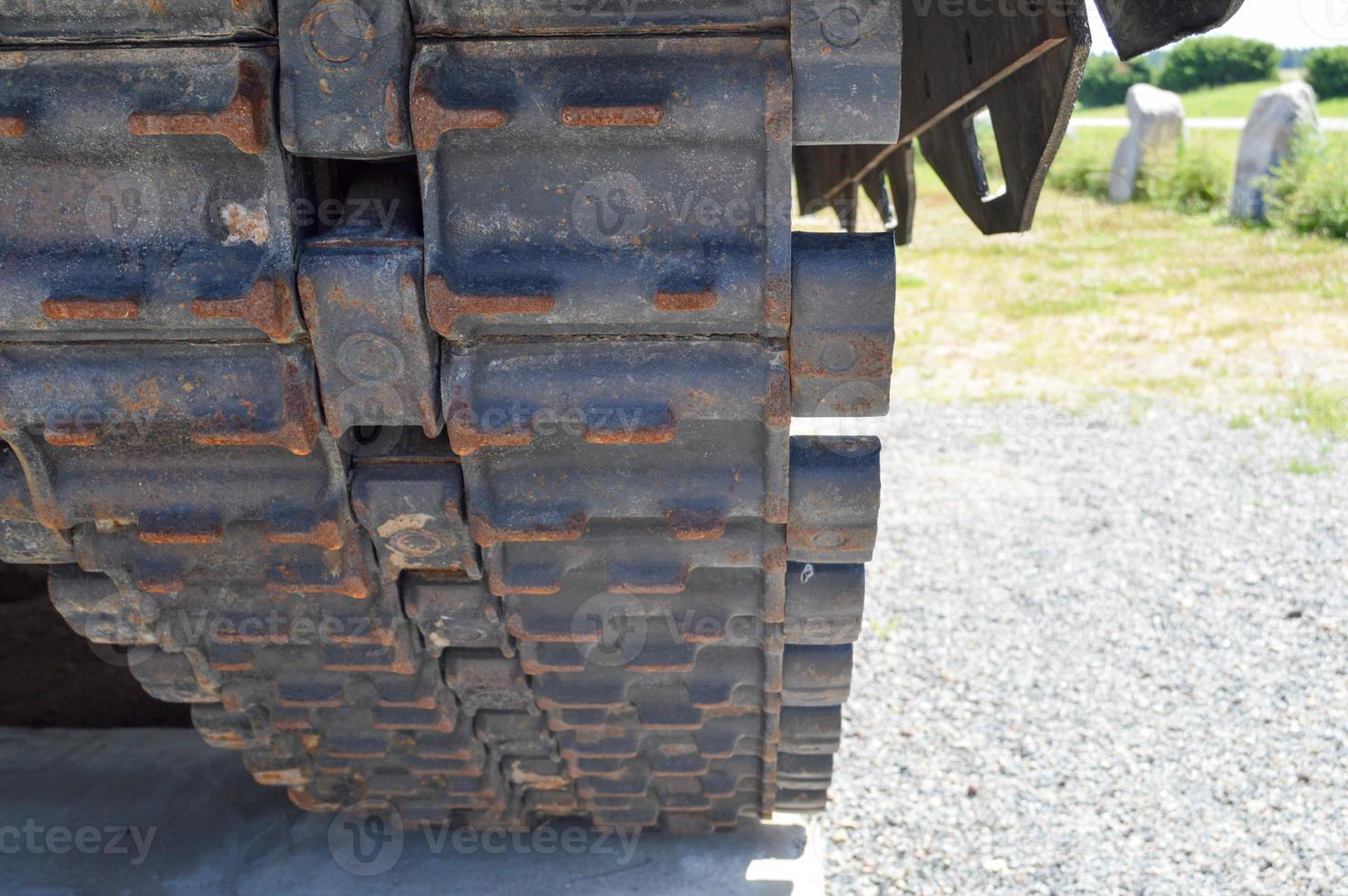 Rusty iron dirty metal heavy track caterpillar of a large green military off-road armored deadly dangerous Russian Syrian battle tank and bottom photo