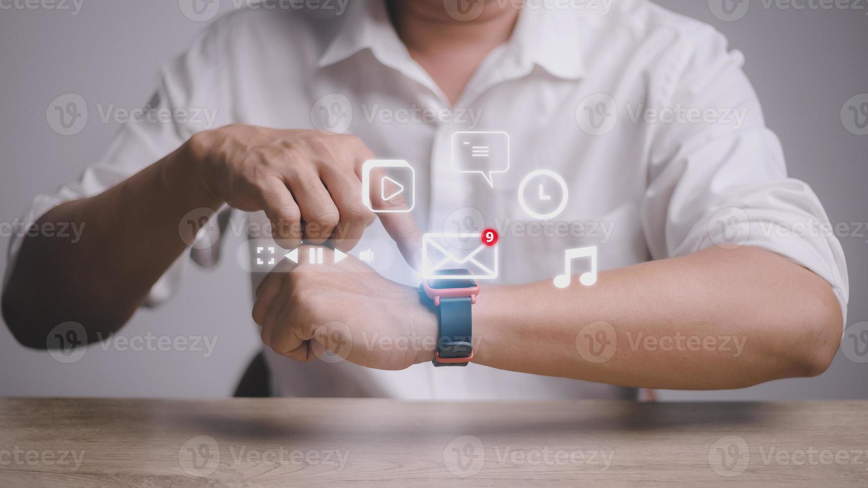 Man working with smart watch in office. New message received notification on screen photo