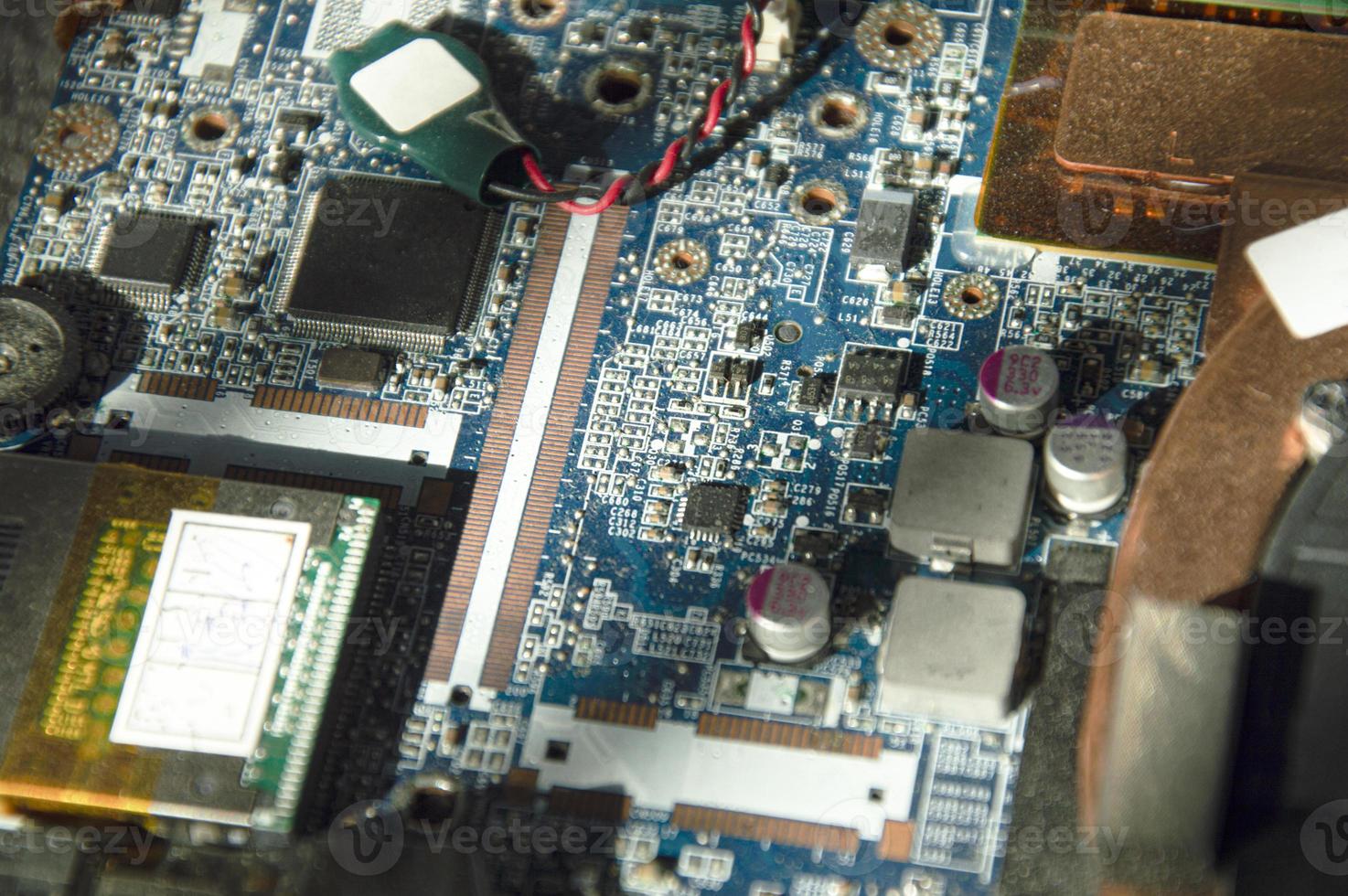 Picture of top view of old motherboard, dusty condition. and the sunlight shines through photo