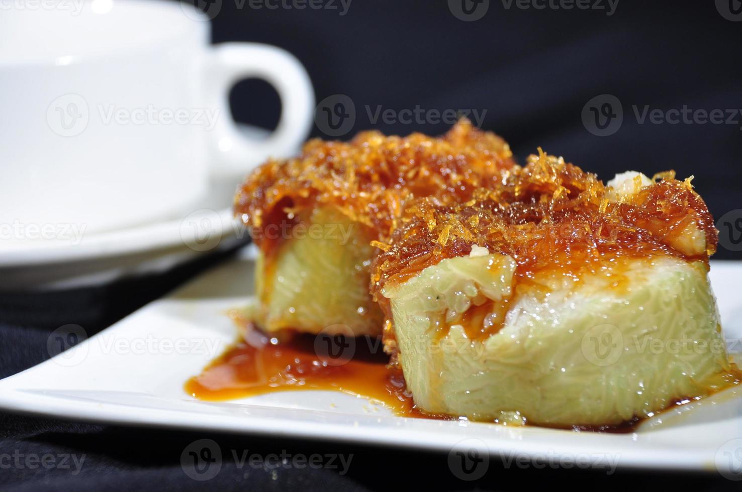 Lopis cake made of sticky rice topped with brown sugar and coconut photo