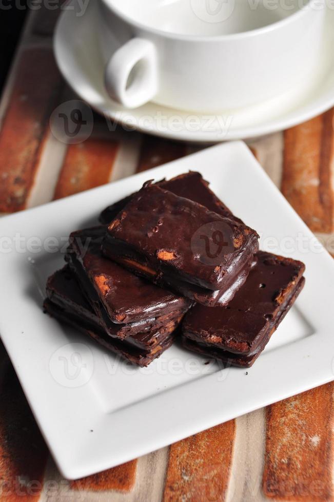 Chocolate covered biscuits on a white plate photo