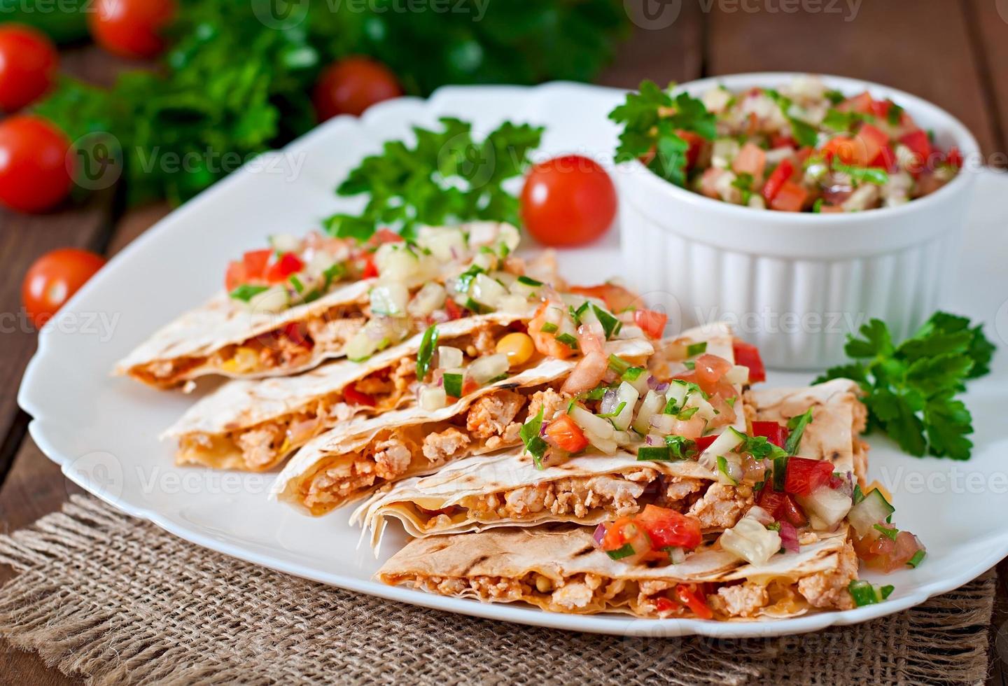 Mexican Quesadilla wrap with chicken, corn and sweet pepper and salsa photo