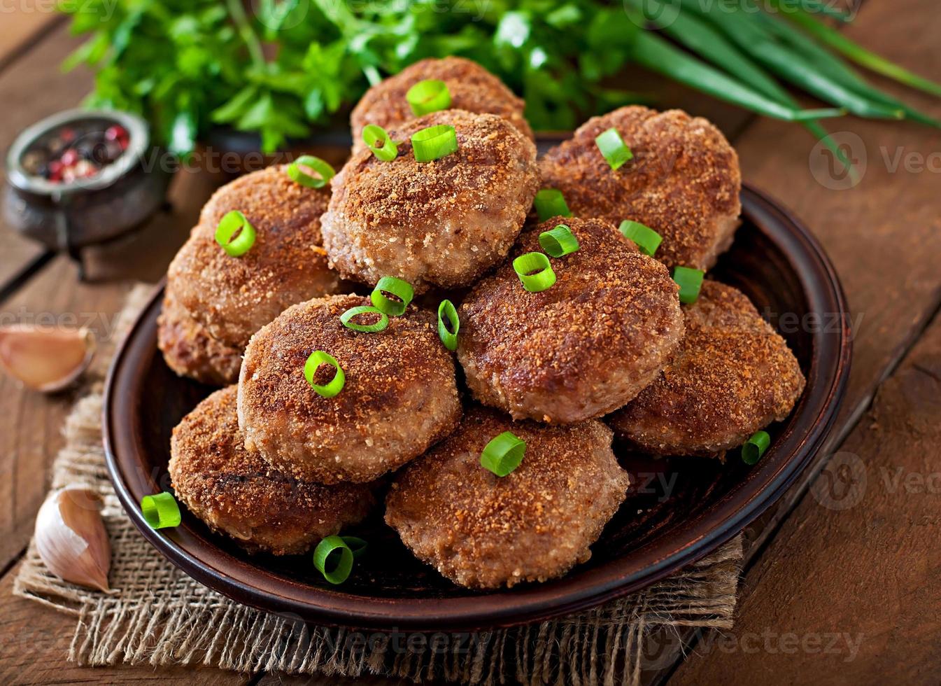 Juicy delicious meat cutlets on a wooden table in a rustic style. photo