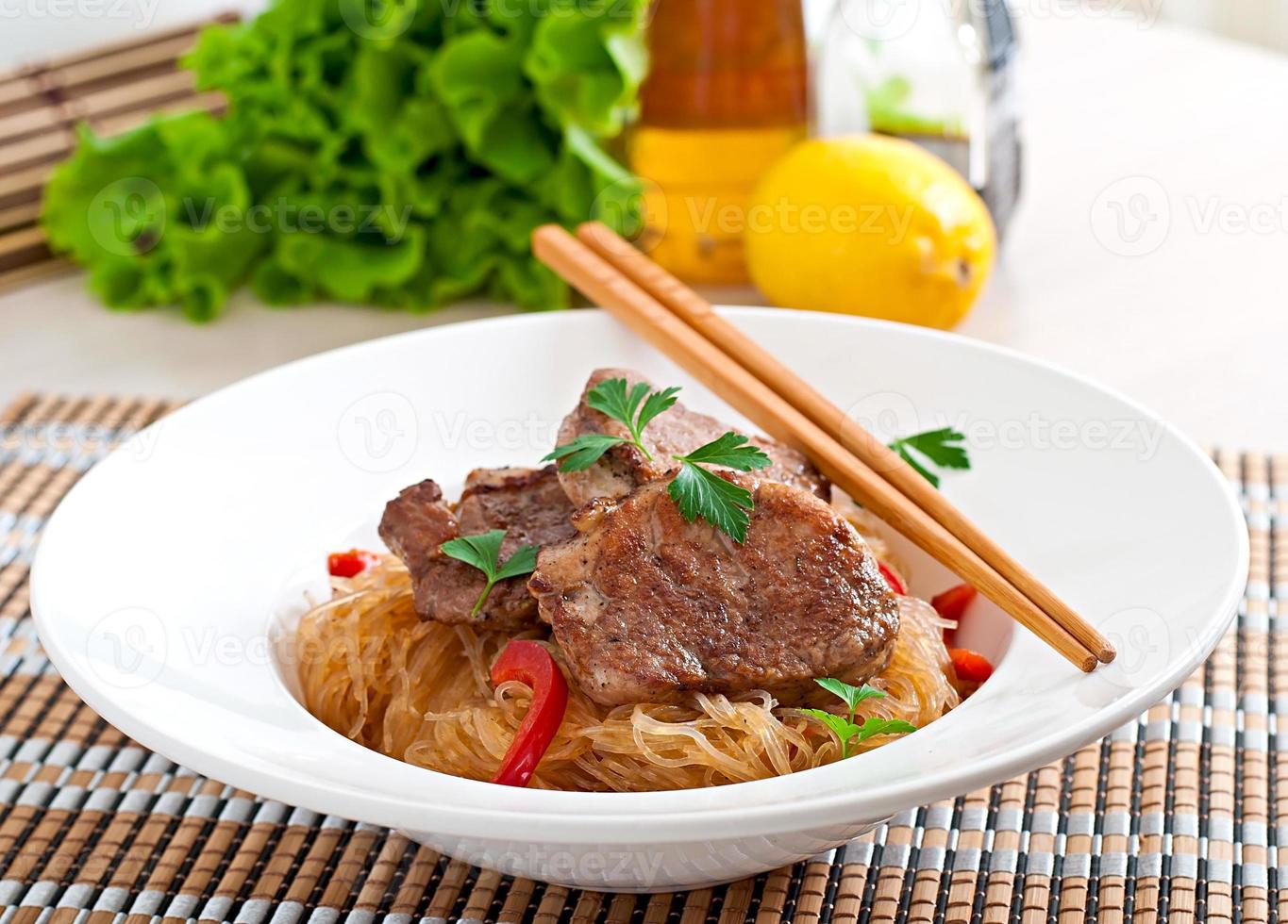 Pork medallions in oyster sauce with noodles photo