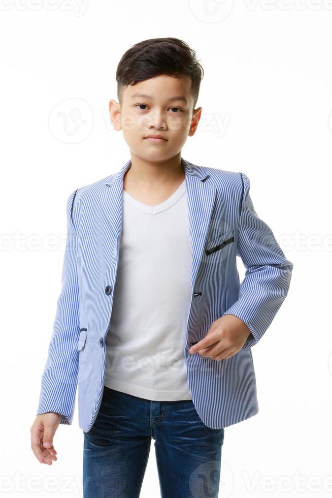 Half-body portrait of a young Asian boy in a casual jacket posing confidently looking at the camera on a white background. photo
