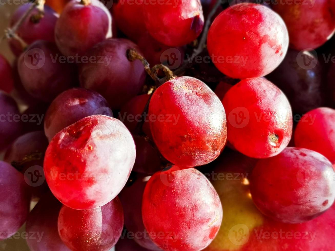 Ripe red grape. Pink bunch with leaves isolated on white. With clipping path. Full depth of field. photo