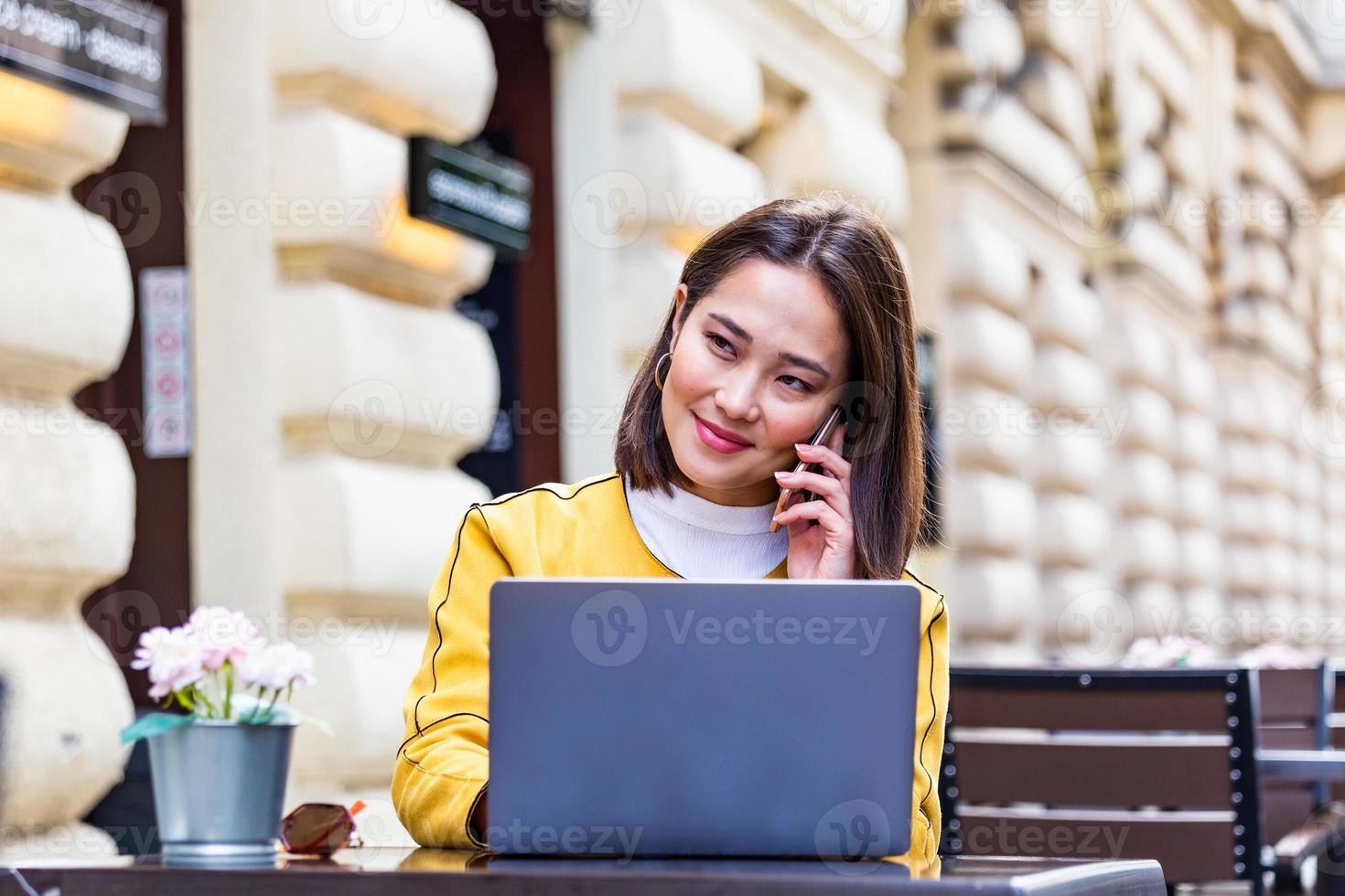 Young Asian businesswoman is working in a cafeteria in her break. Woman taking a break. Enjoying work from coffee shop. Doing Business From coffee shop photo