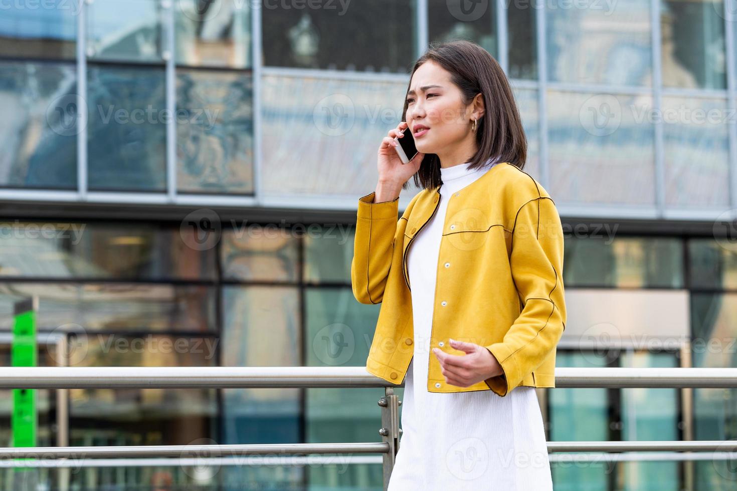 Businesswoman in formal wear having trouble with contracts talking on the phone. Businesswoman angry abount about paperwork failure at workplace, executives having conflict photo