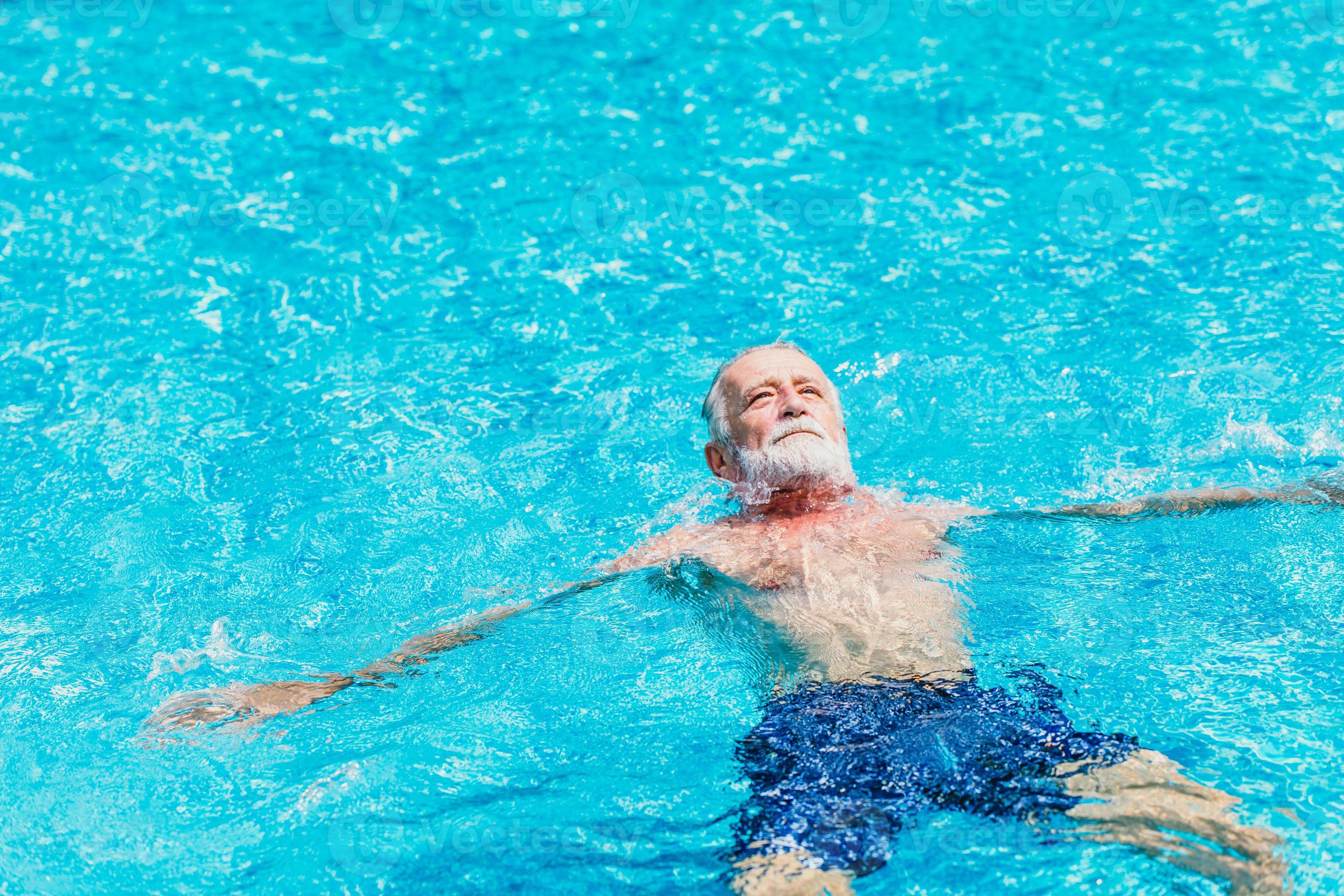 Healthy elder enjoy relax swimming in the pool alone vacation holiday