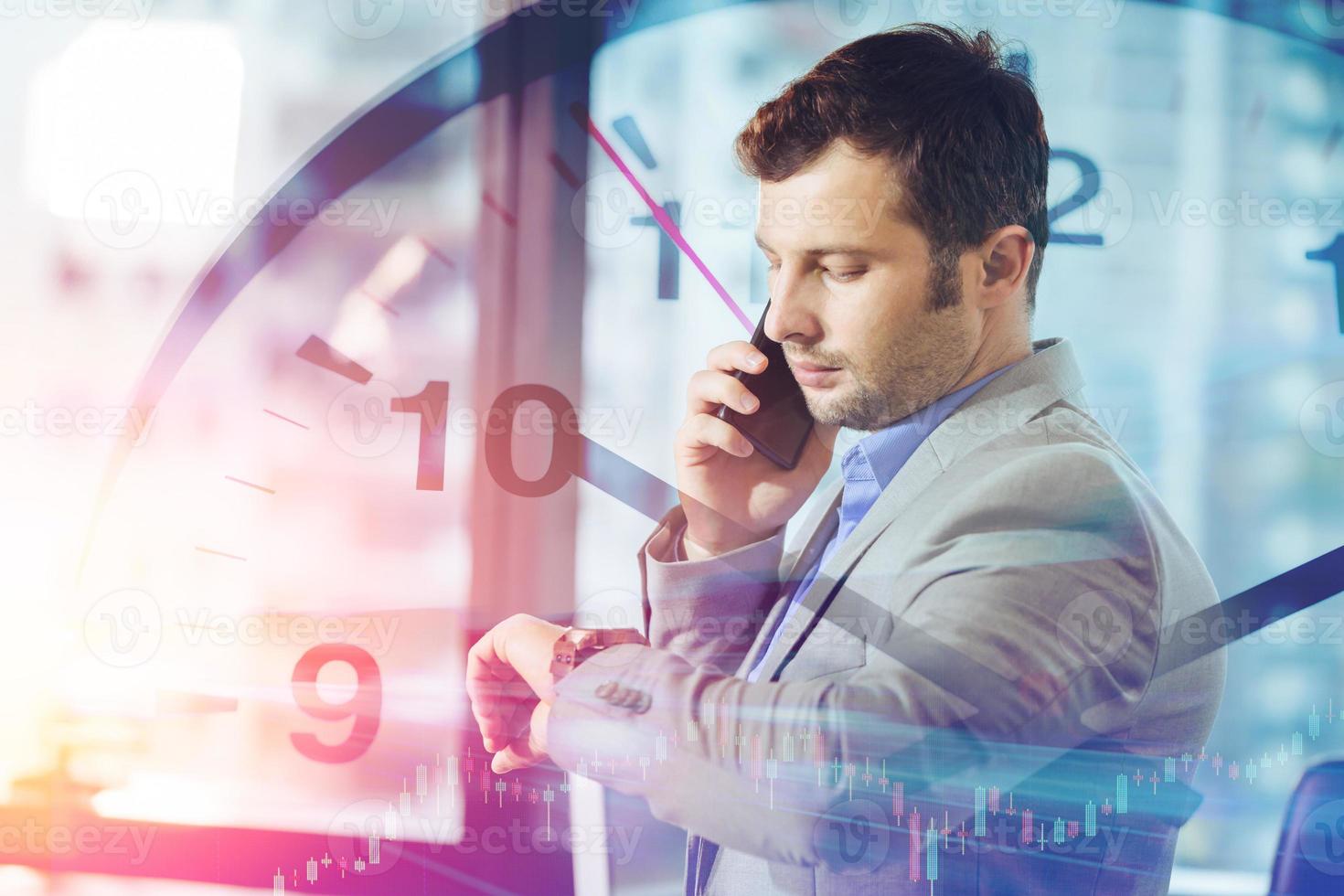 Business times concept. businessman calling smart mobile phone while looking what time at his wristwatch overlay clock face. photo