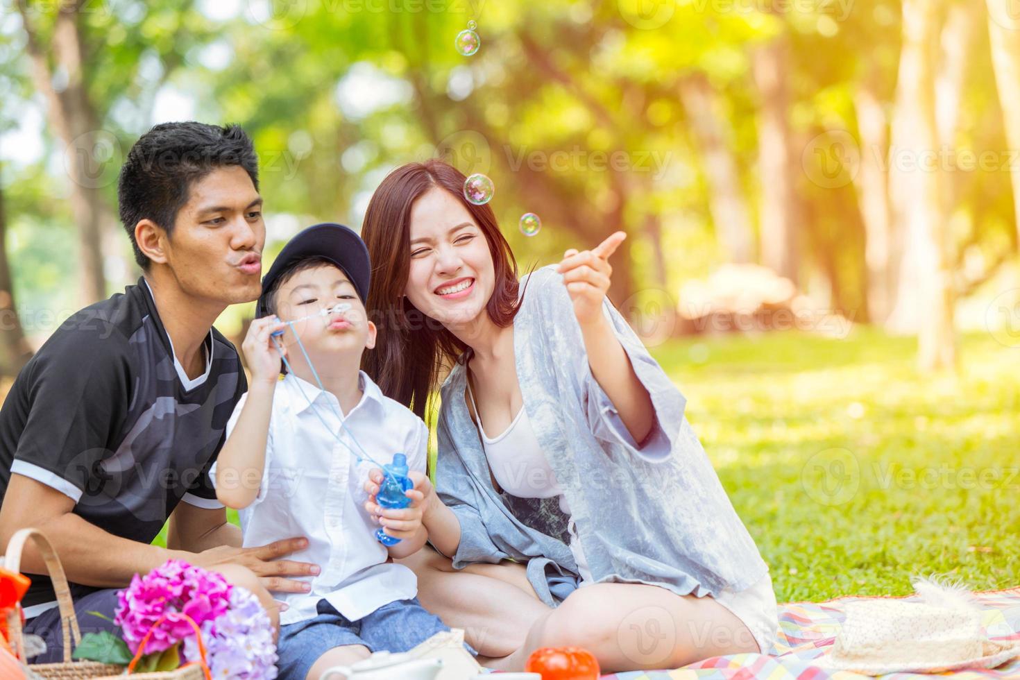 Asian Family Enjoying Playing Bubble Together in Green Park Natural outdoor background photo