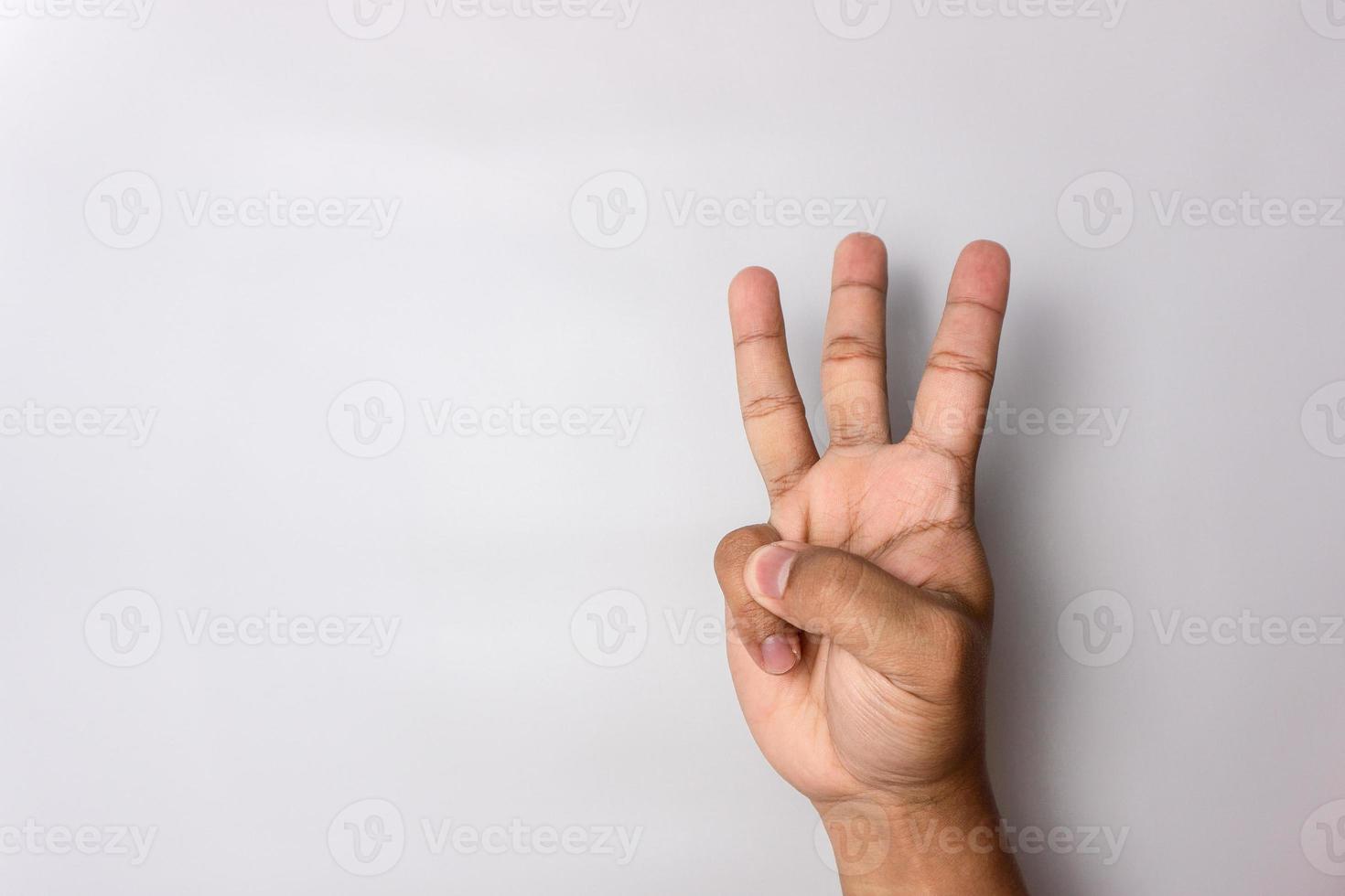 man hand number three gesture. number 3 hand sign isolated on white. pointing the finger photo