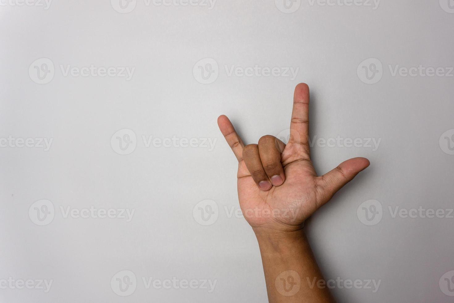 I love you  gesture in sign language. rocker hand gesture isolated on white background. symbol of rock and coolness photo