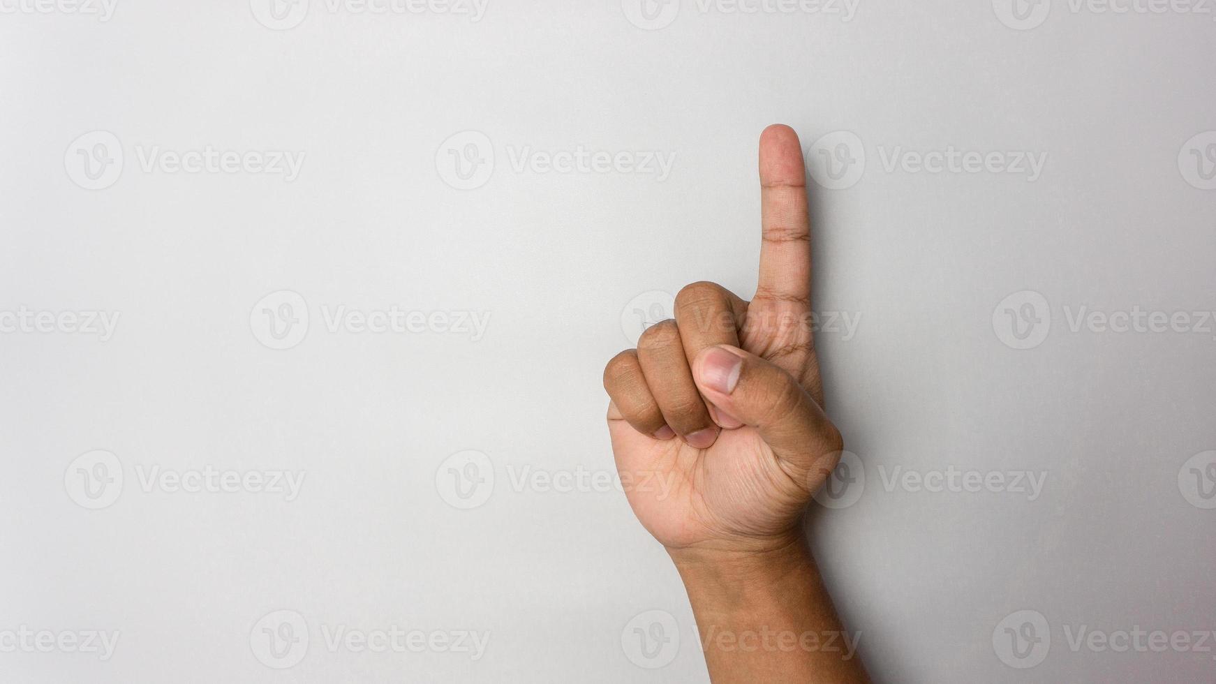 pointing the finger. man hand number one gesture. number 1 hand sign isolated on white photo