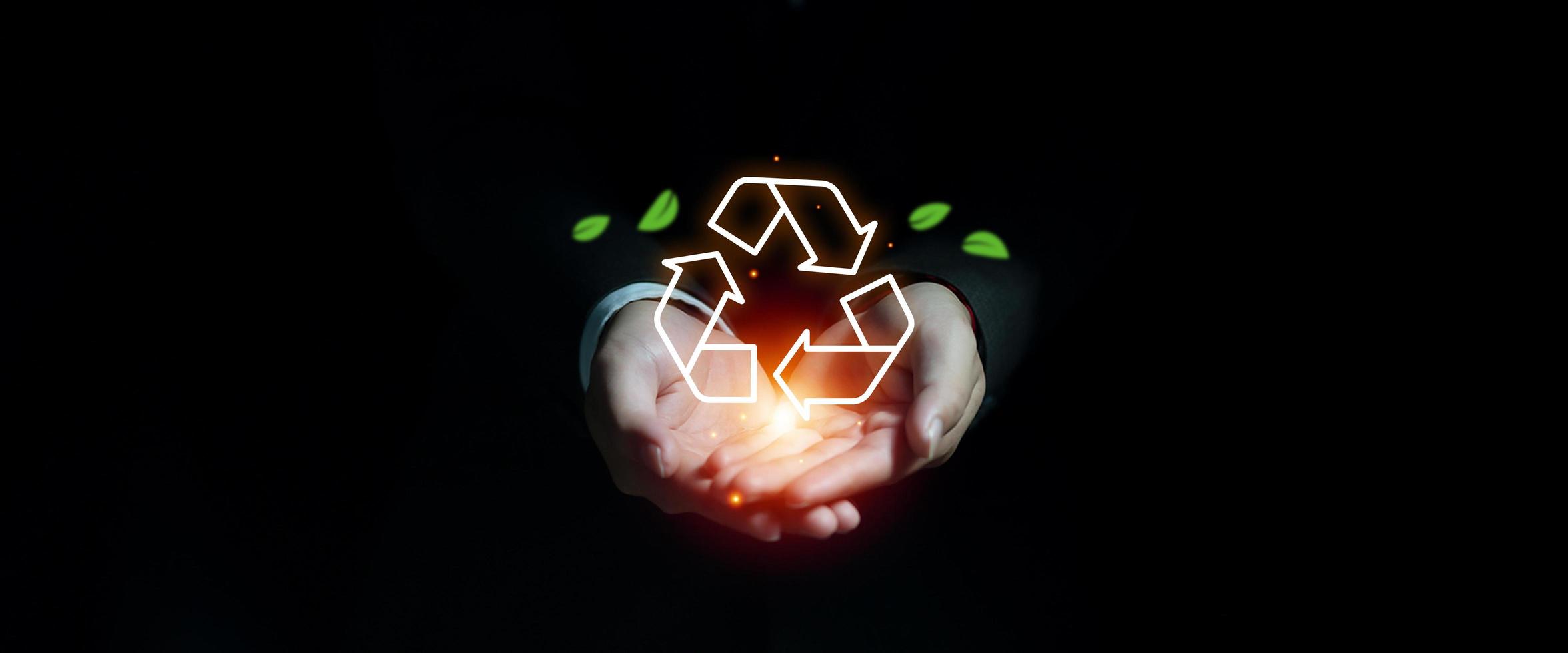 Businessman hand showing recycle icon with leaves banner, Environmental sustainability and reduce pollution for future,  Sustainable strategy to eliminate waste and pollution for future concept photo