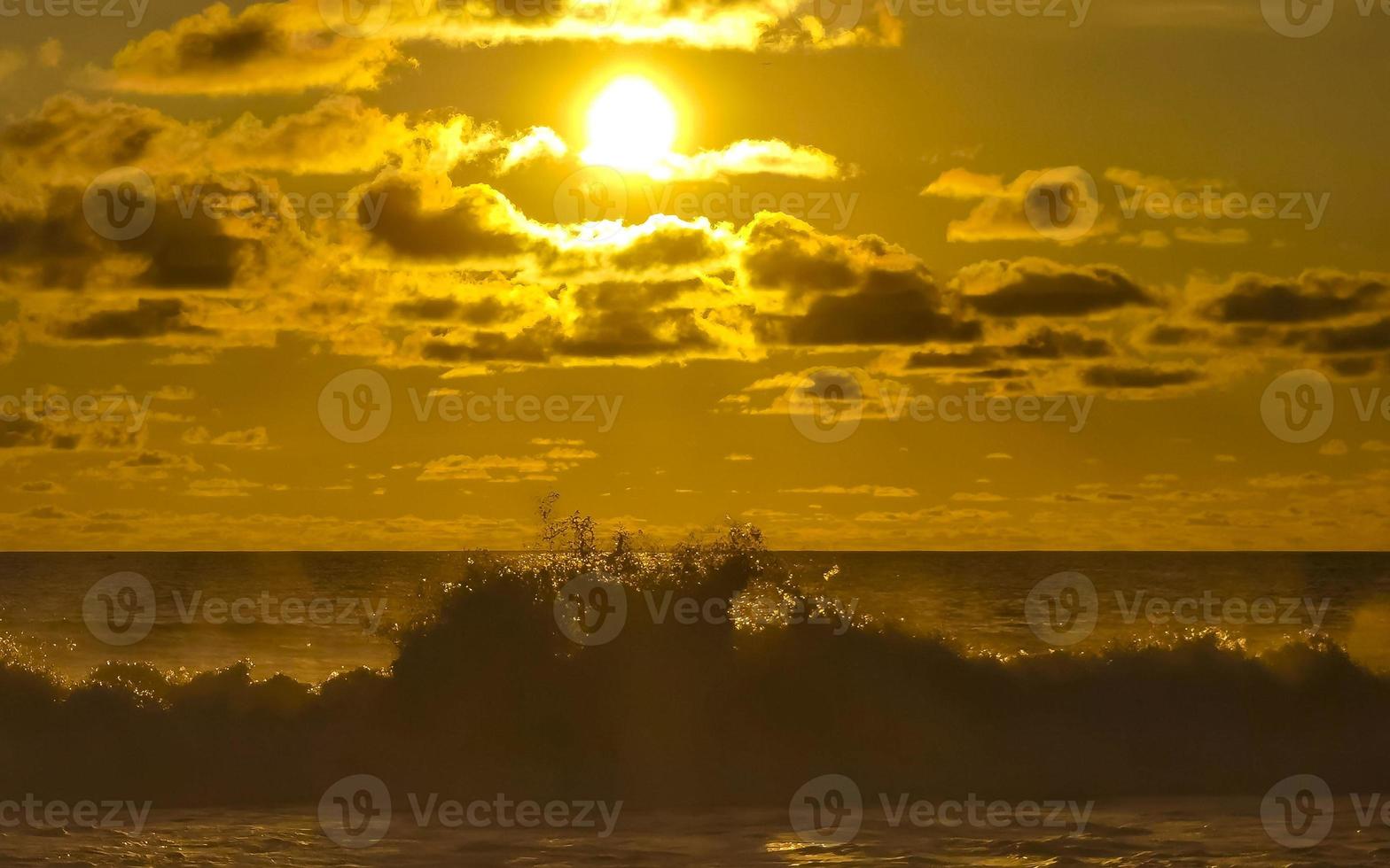 Colorful golden sunset big wave and beach Puerto Escondido Mexico. photo