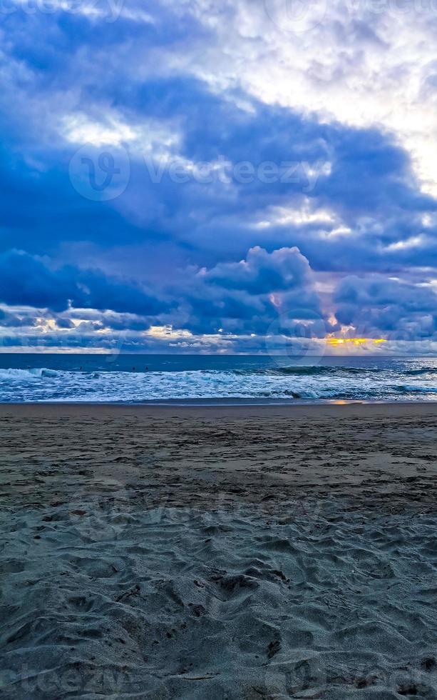 Colorful golden sunset big wave and beach Puerto Escondido Mexico. photo