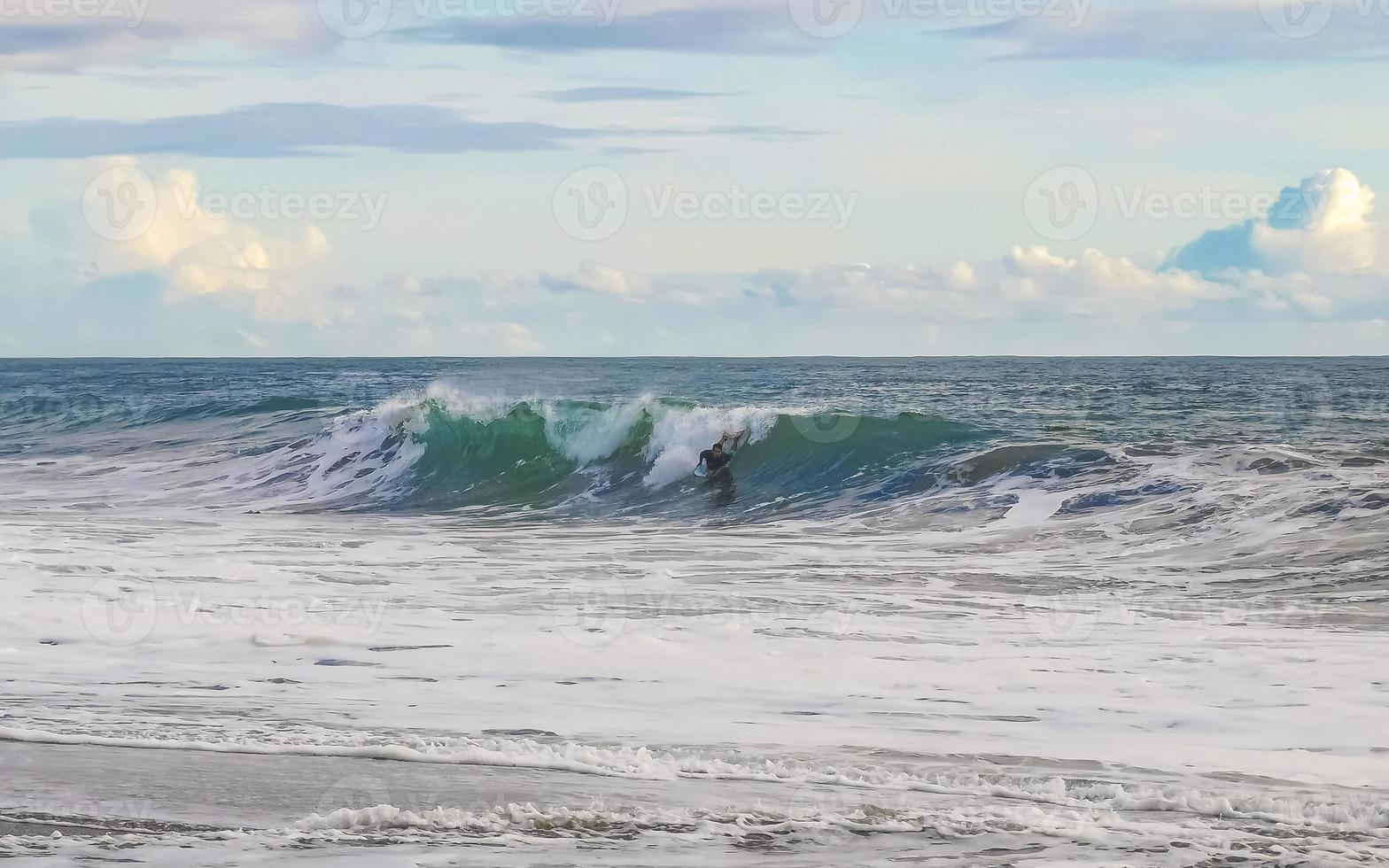 Surfer on extremely huge big waves beach Puerto Escondido Mexico. photo