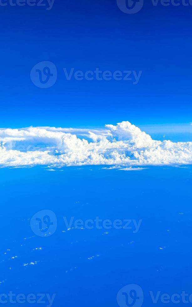 Flying above the clouds with view from the plane window. photo