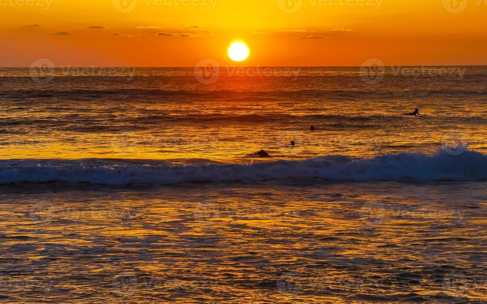 Colorful golden sunset big wave and beach Puerto Escondido Mexico. photo