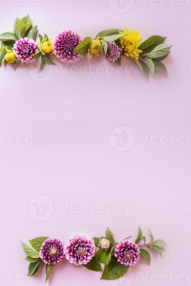 vertical view of two parallel flower garlands of bright autumn flowers. delicate purple background. space for text. holiday card, frame. photo