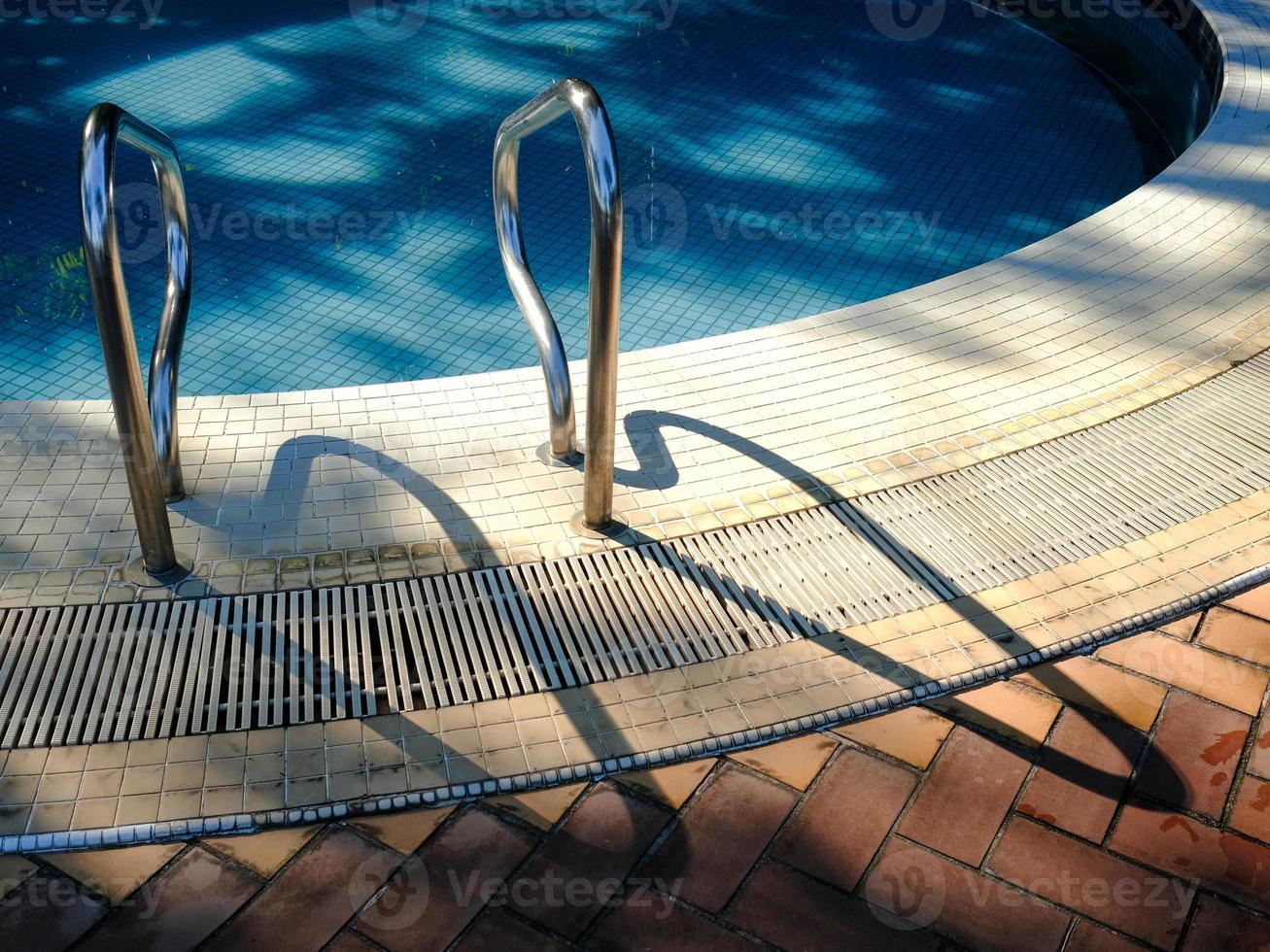 Close-view of tiled swimming pool deck photo